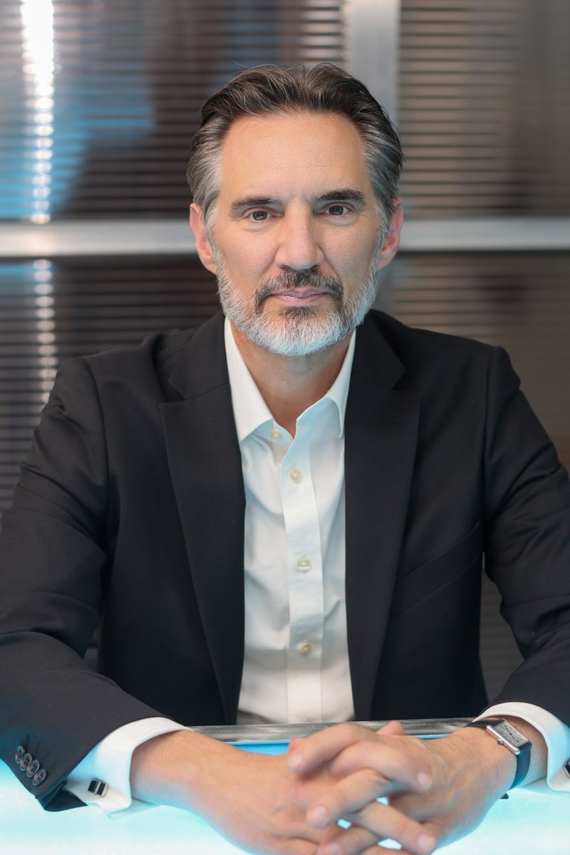 Mike Shipman, Founder of Shipman Law, seated at a desk in a dark suit