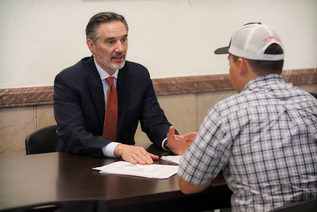 Mike Shipman meeting one-on-one with a client to discuss their case
